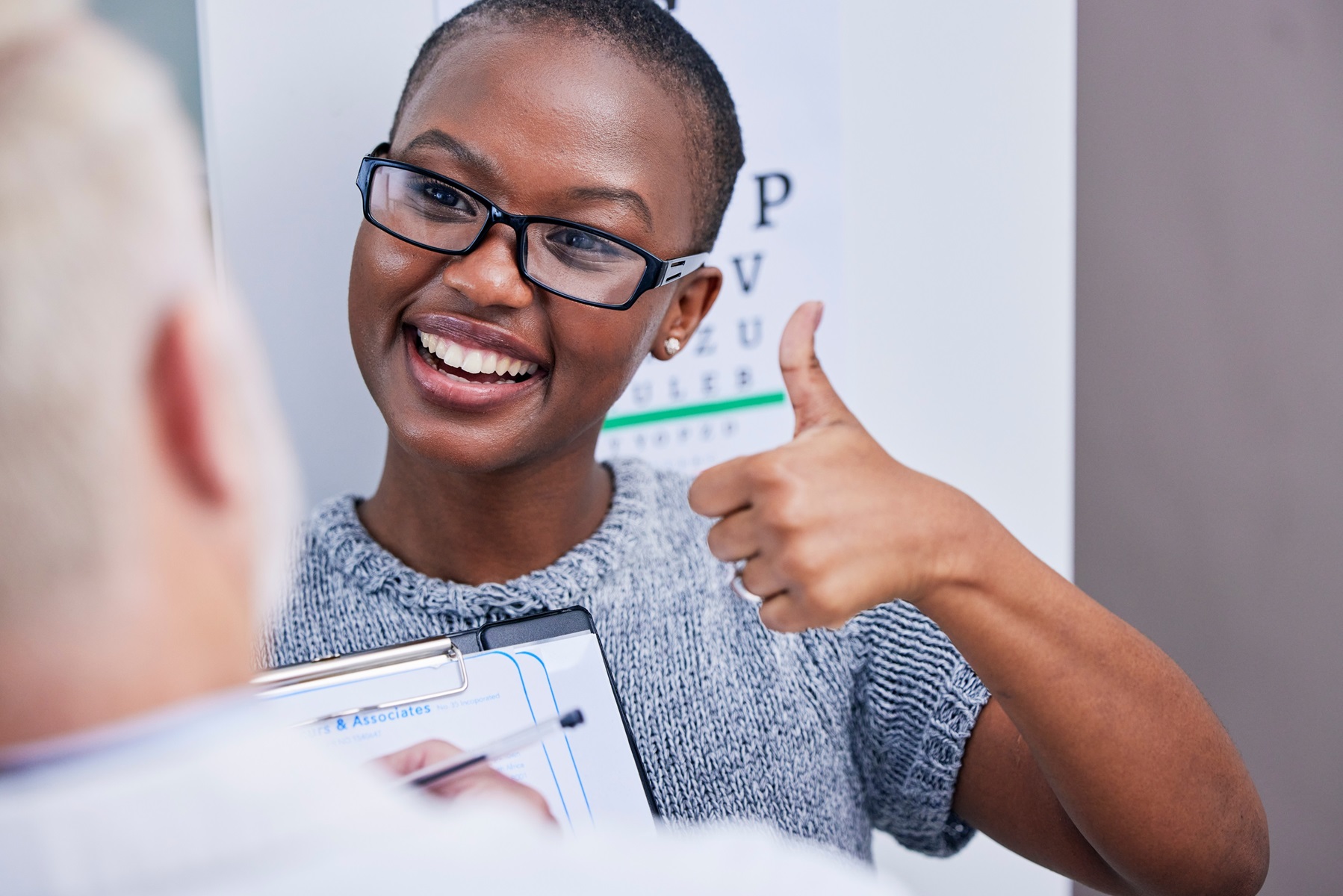 Optician assisting a patient